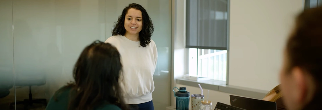 Colleagues engaged in a discussion, fostering growth and collaboration through BeOne Careers.